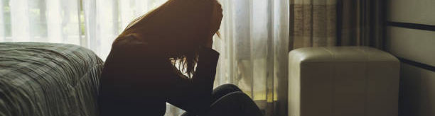 680834894 Woman sitting in the dark